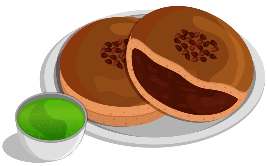 A photo of two Dorayaki pancakes on a plate with a cup of Japanese green tea.